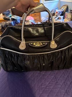 Brand new suitcase on wheels with matching tote bag