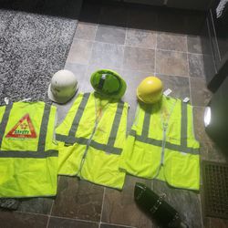 Three Hard Hats And Three Safety Vest 