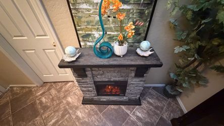 Beautiful faux stone electric fireplace /tv stand in excellent condition