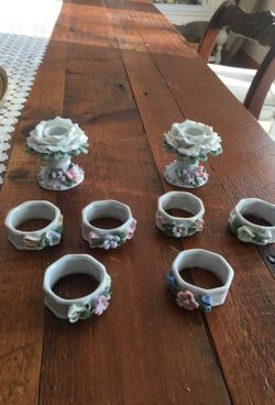 Two ceramic candle holders and six ceramic napkin holders.