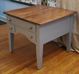 Natural wood and grey end tables or accent table with three drawers.