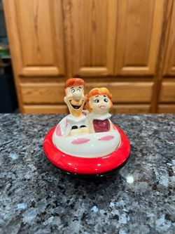 Ceramic Jetsons  Magnetic Pair of Salt and Pepper Shakers.  Preowned never used.  Has been on display in a cabinet with a very large salt and pepper s
