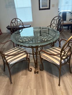 Dining room set with 4 padded chairs.