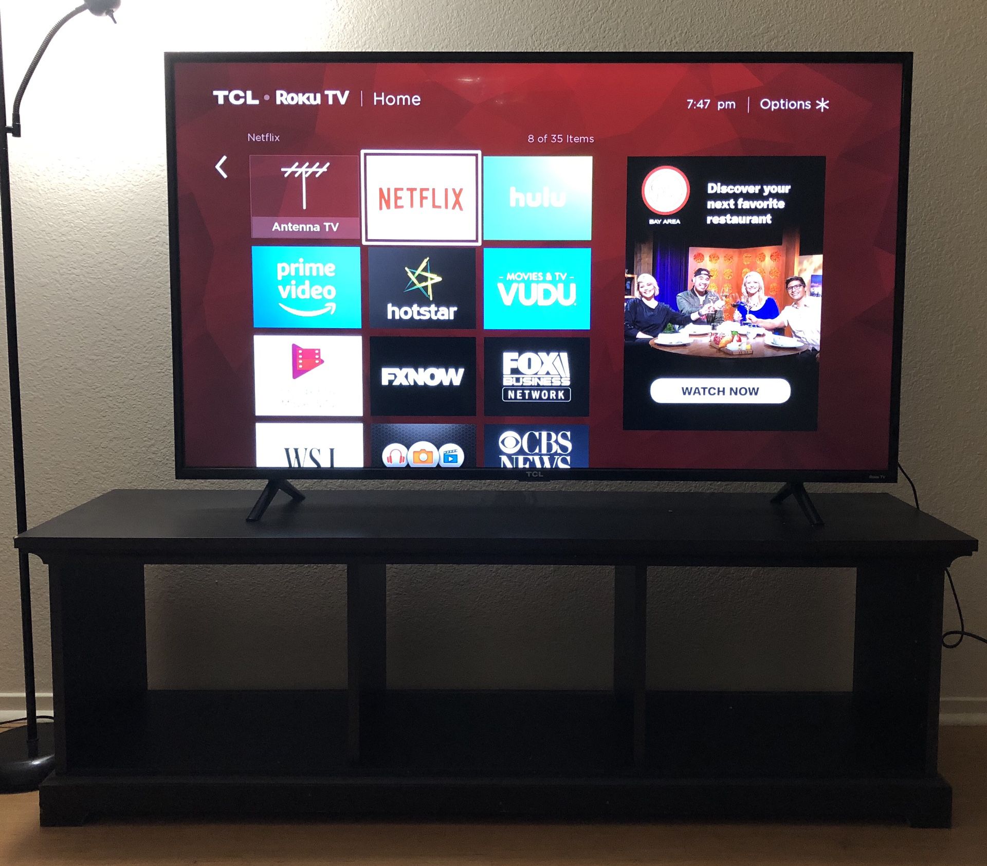 TCL 55 inch Roku TV and wooden TV stand