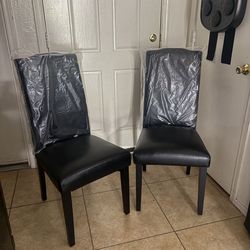 2 black dining chairs