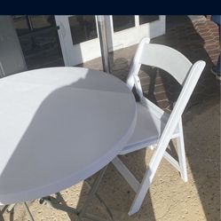 white folding chairs with table