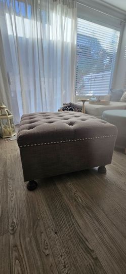 Square grey tufted storage ottoman