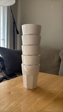 Five white plastic cups