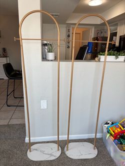 2 gold clothing racks