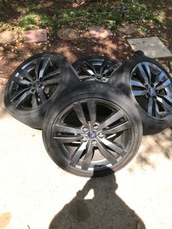 3 Subaru rims with 2 good tires 245/40/18
