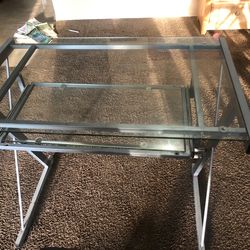 Glass table the bottom slides out go for homework or reading or laptop or small TV it comes with a  black Rolling chair