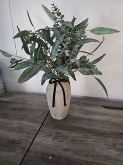 Vase with artificial plant.