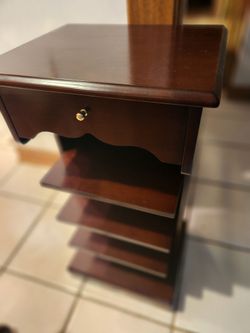 Gently Used q5" wide x 15" deep x 30 1/2" high End Table/ Nightstand on Wheels Has a Drawer Shelves & Magazine Rack