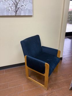 Four blue chairs with wood trim, and one wood side table
