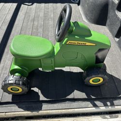 Small John Deere sit on tractor