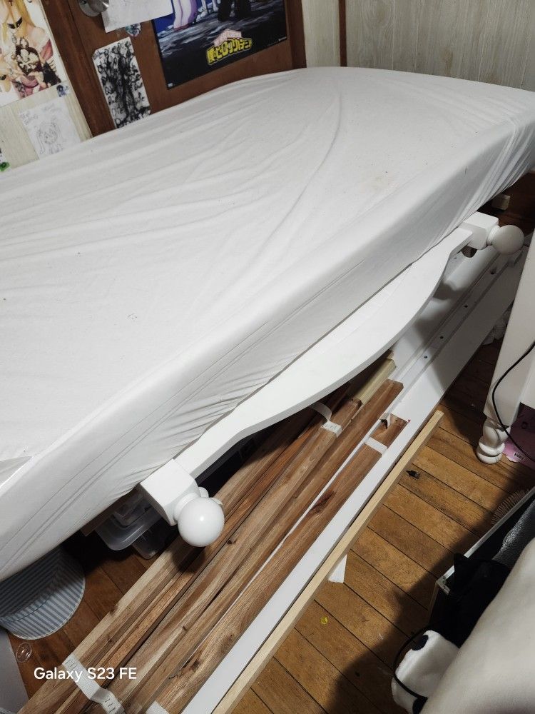 two white wooden twin beds.