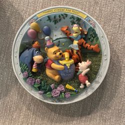 A collectible 3D plate featuring Winnie the Pooh characters, titled 'Three Cheers for Pooh'.