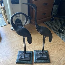 Bronze statues of two cranes by Bombay Co. with green marble base.