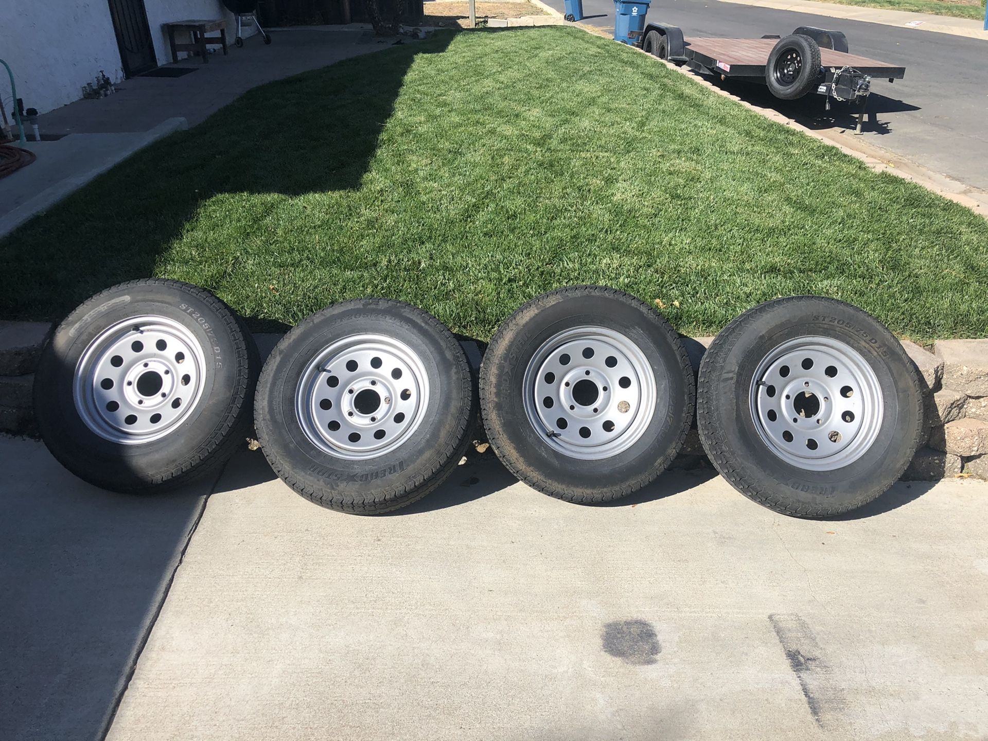 Set of 4 trailer tires and wheels. 5 lug. Only 2 years old.