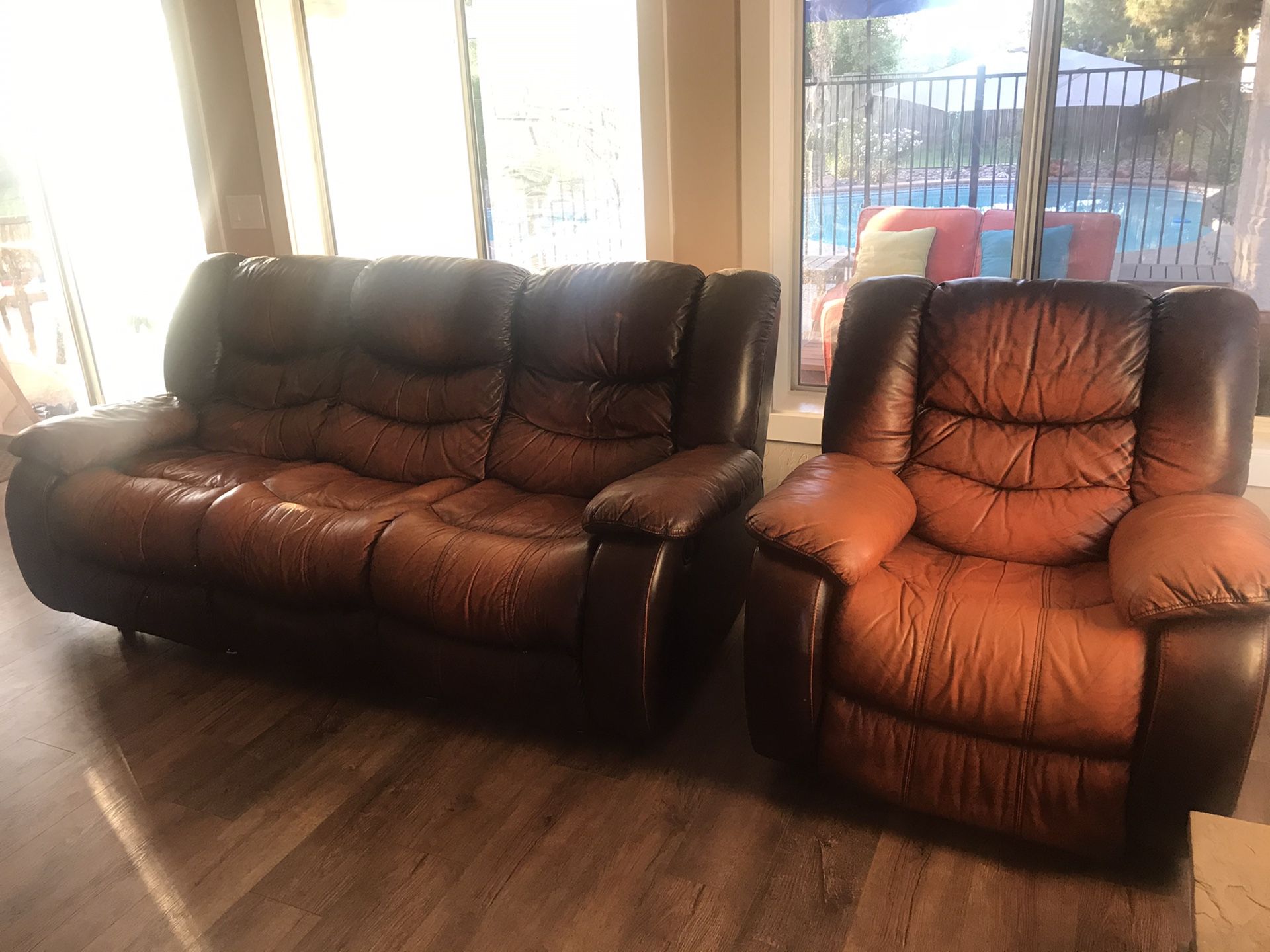 Brown leather recliner couch and one reclining rocker from Ashley Furniture for Sale in Gilbert
