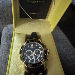 Mens black and gold Invicta watch