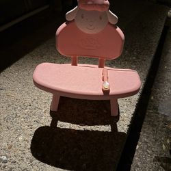 Small plastic seat and tray for a large doll.