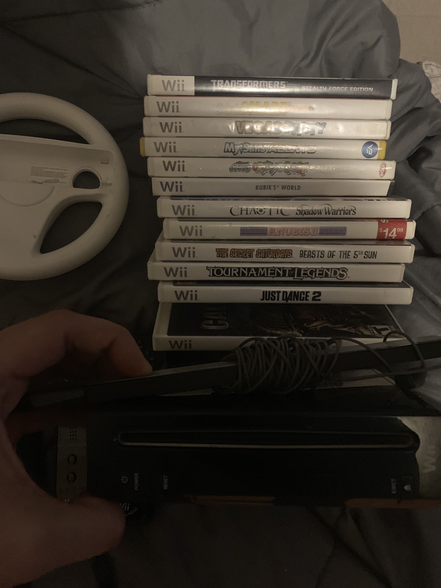 Nintendo wii (first generation) GameCube compatible. Two game systems in one. Comes with 3 wireless remotes, 1 nunchuck, a steering wheel & 12 games