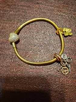 Gold pandora bracelet with 2 charms