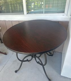 Vintage-style round table with wrought iron base