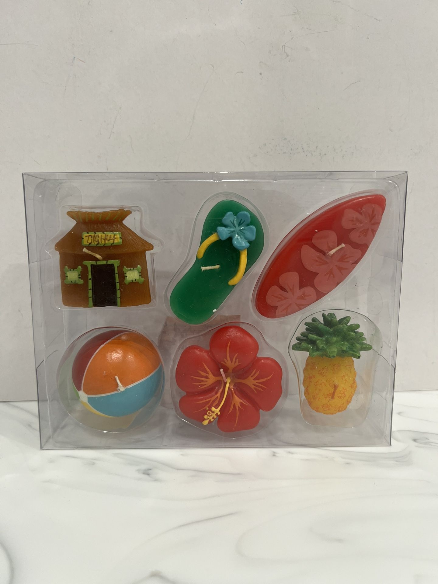 New in Package Set of 6 Small Beach / Luau Floating Candles Decorative candles with a tropical or beach theme. The set includes candles shaped like a