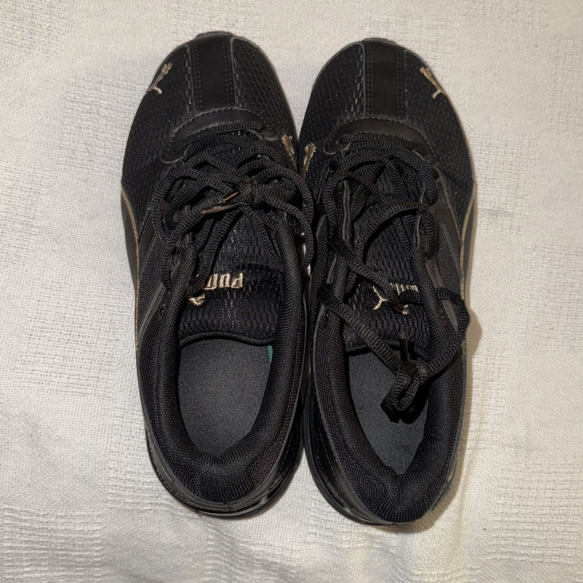 Puma Woman’s Black And Gold, Size 6.5