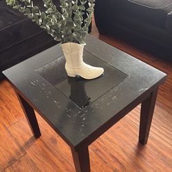 Black sofas with a small side table