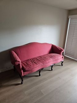 Vintage red sofa with embroidered pillows
