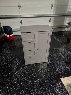 Grey cabinet with drawers and shelves