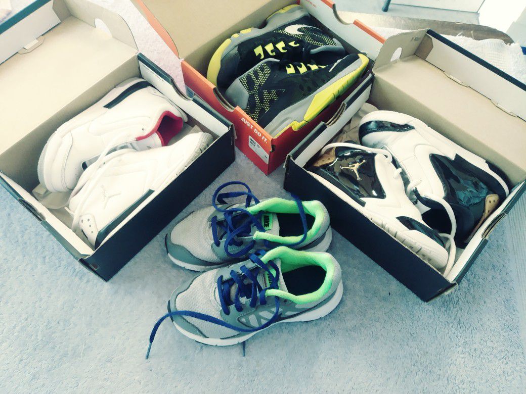 Four pairs of Nike's and Jordan shoes.