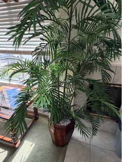 Artificial tree with decorative base.