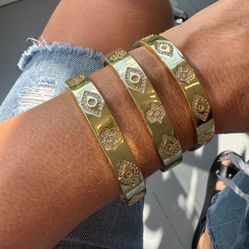 MYSTIC BANGLE features delicate hamsa and evil eye-symbols of protection and good fortune