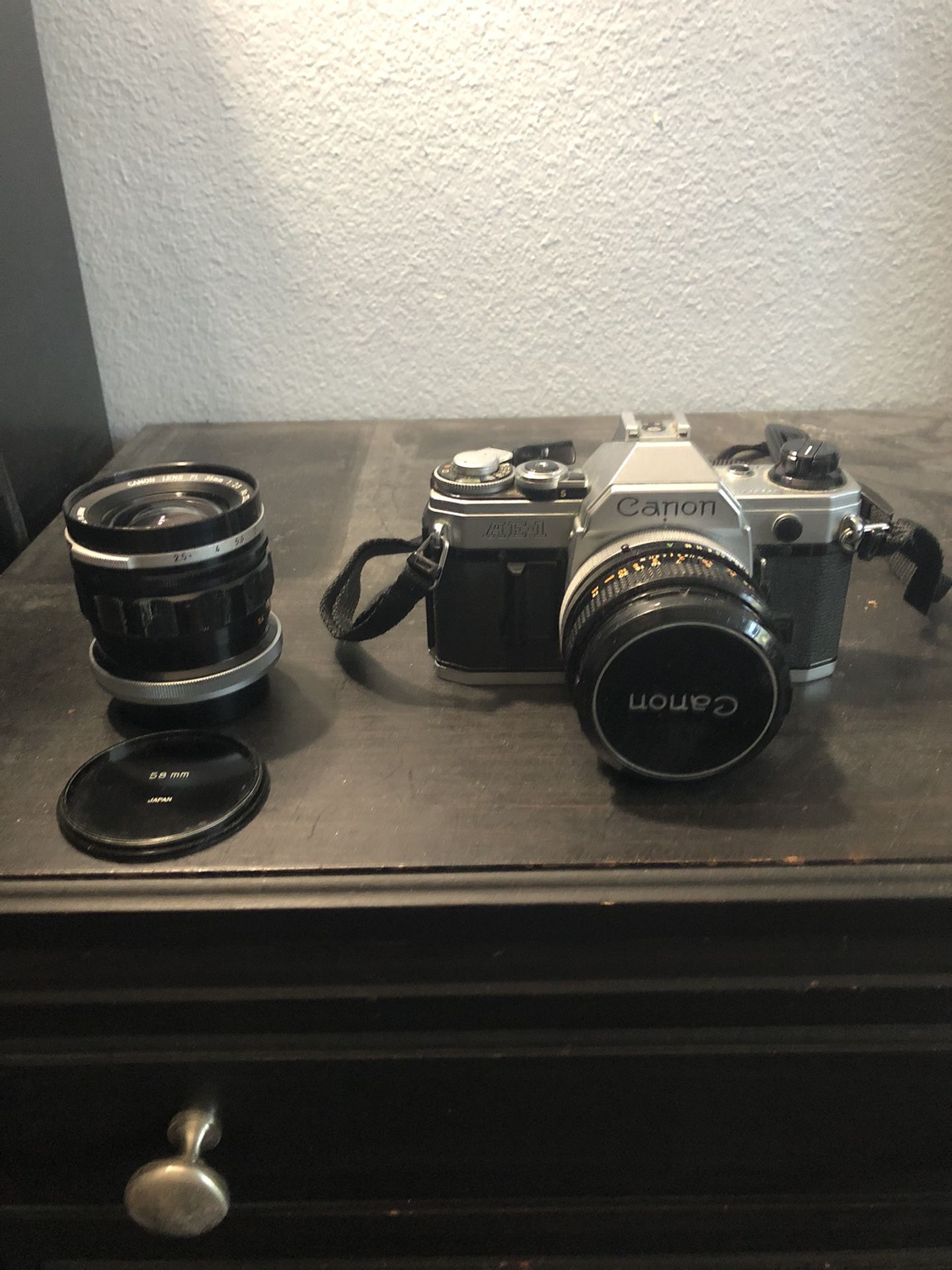 Canon AE1 SLR camera body w/35mm and 55mm lenses and flash. Instruction manual. Excellent condition.