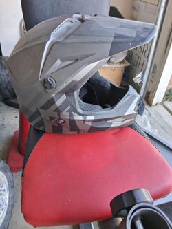 FLY Racing Kinetic helmet features a matte charcoal and black graphic design