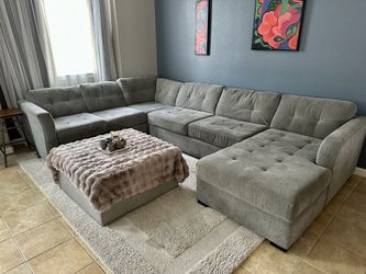 Large gray fabric sectional sofa with lounger
