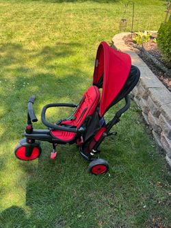 Preowned Smart Trike tricycle has has sun hood, removable bag and pedals