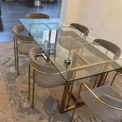 used CB2 glass dinning table and 6  chairs 