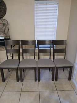 Dark brown table with grey chairs and bench