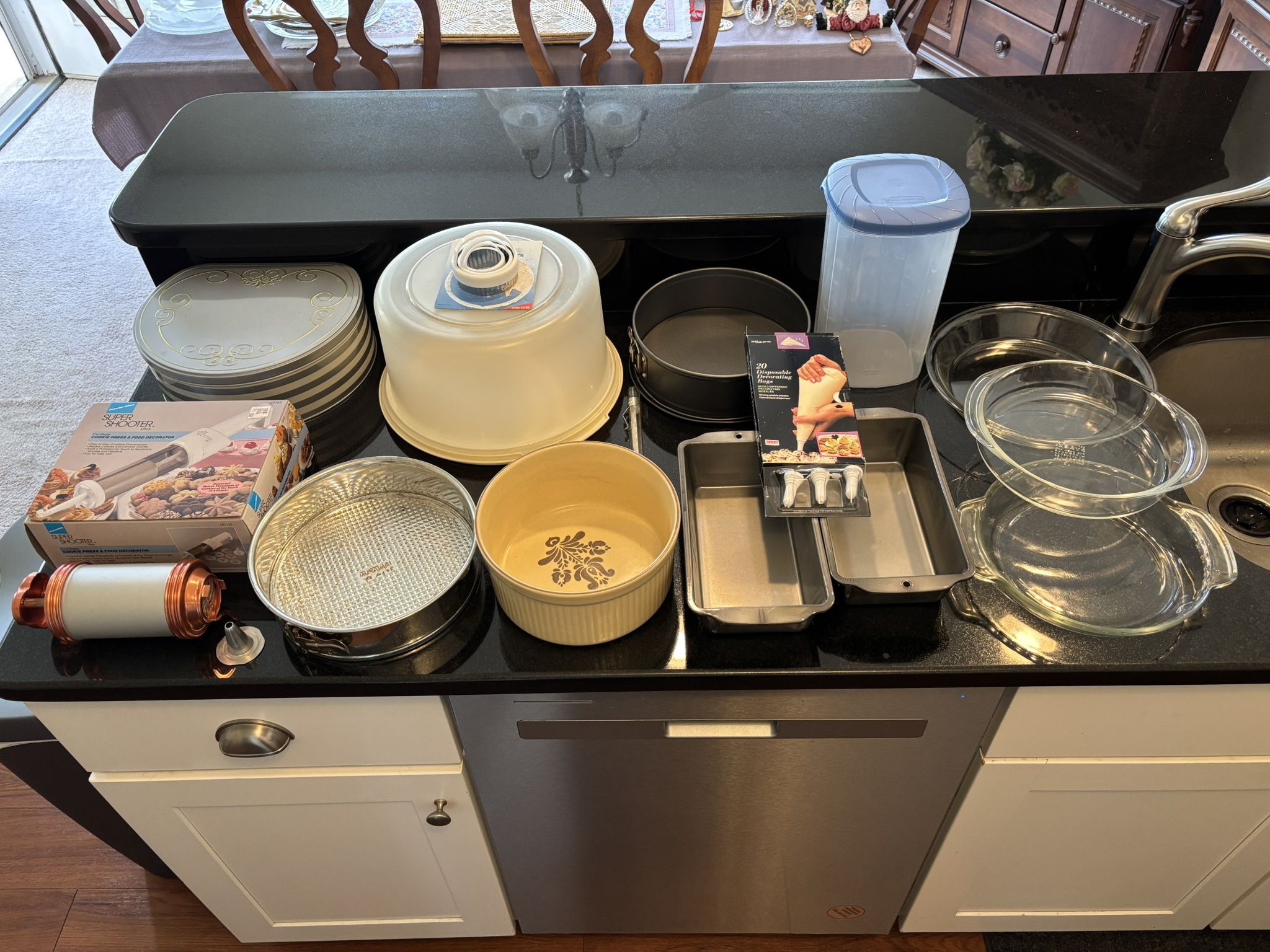 Baking Essentials lot of 16+ items, good to new condition.  2 springform pans, 2 nonstick loaf pans, 3 Pyrex glass pie plates, 1 large soufflé dish, 1