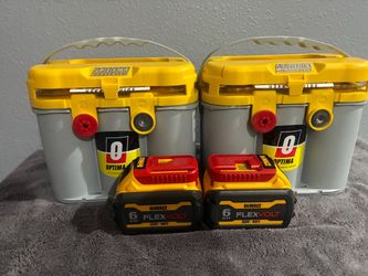 Two yellow top optimum batteries and two DeWalt batteries .