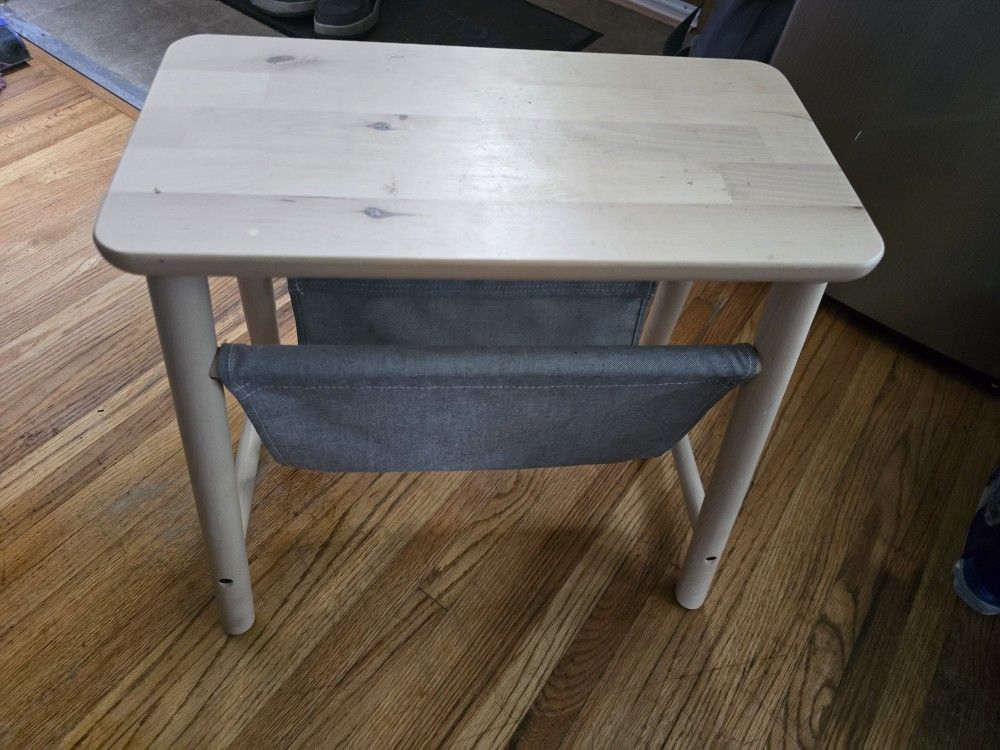 Wooden stool with holder underneath