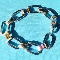 18k (750 marking)  two-toned link bracelet with square links and bezel-set gemstones.