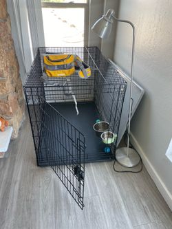 huge dog crate with two bowls
