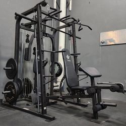GREAT DEAL!!! SMITH MACHINE INCLUDES EVERYTHING IN THE PICTURE. SMITH MACHINE, BENCH, OLYMPIC BARBELL, PLATES AND FLOORING. (EXCELLENT CONDITION  )