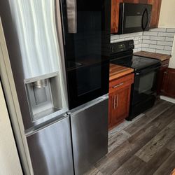 Lg Refrigerator, Full Kitchen cabinets. oven, microwave etc